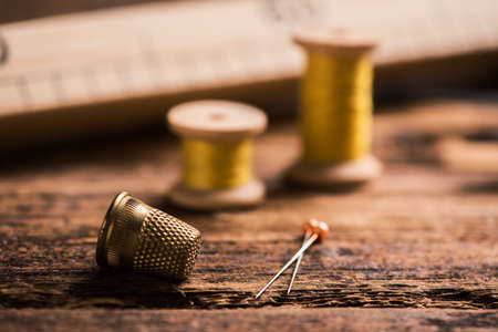 Sewing tools on wooden tableの写真素材