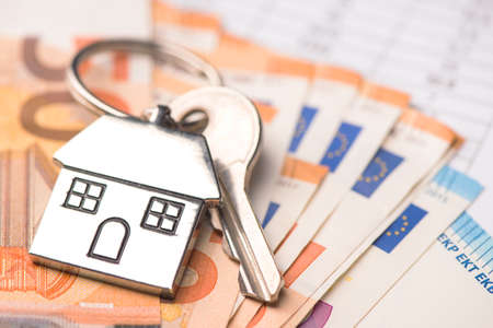 Key house shaped ring with euro moneyの写真素材