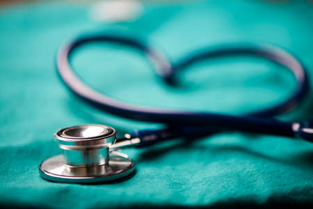 A stethoscope shaping a heart on a medical uniform, closeupの写真素材