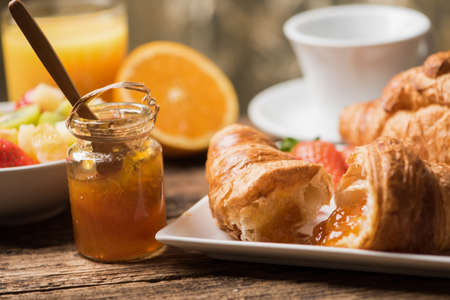 Fresh tasty croissants with berries on blue wooden backgroundの写真素材