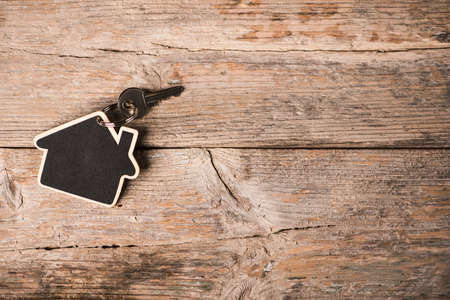 House-shaped key on a wood rustic tableの写真素材