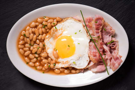sunny side up eggs with organic bacon, hashbrowns and crsipy toastの写真素材