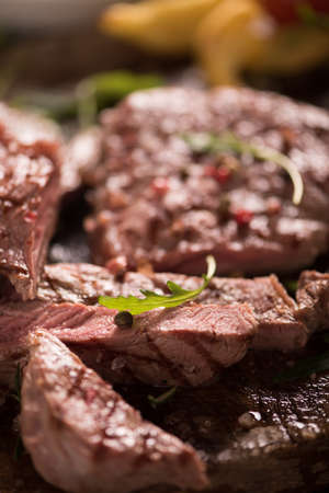 grilled meat with herbs on wooden boardの写真素材