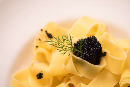 caviar pasta tagliatelle on a white dish. Close up
の写真素材