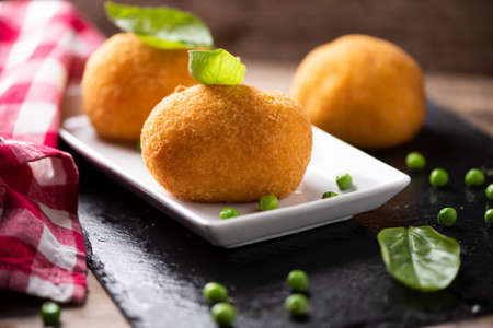 selction of arancini di riso, fried risotto rice balls, italian sicilian food on a plateの写真素材
