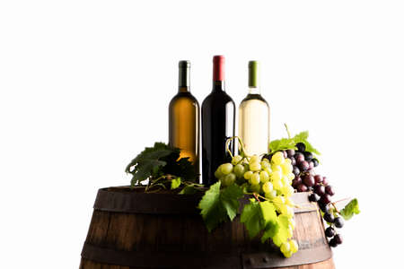 Mixes of bottle ow wine on barrel with grapeの写真素材