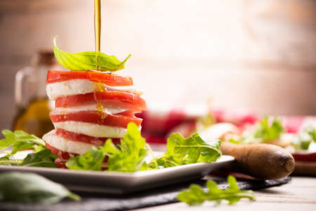 Fesh Italian Caprese salad with sliced mozzarella and herbsの写真素材