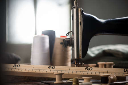 Sewing machine and many sewing utenisils in a workshop placeの写真素材