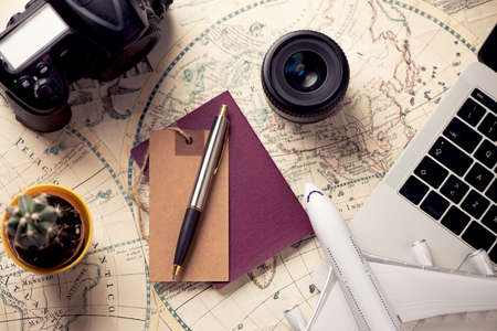Accessories for travel. Passport, photo camera, smart phone and travel map. Top view. Holidays and tourism conceptの写真素材