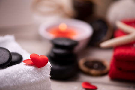 Wellness docoration on valentine's day with candels and stones close upの写真素材