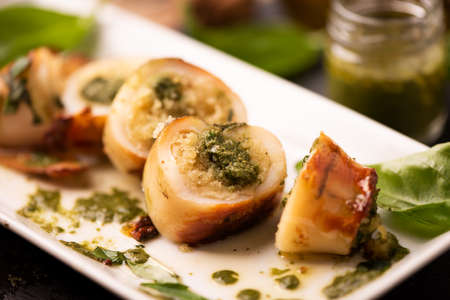 Grilled squid stuffed with basil closeup.の写真素材