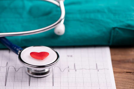A stethoscope on ecg medical report close up
