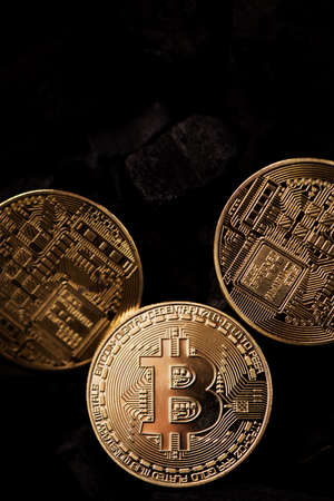 Bitcoin mining concept. Bitcoin cuurency on charcoalの写真素材