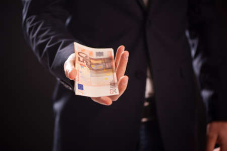 Businessman in suit with euro banknotes close up