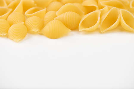 Raw pasta on white surface close upの写真素材