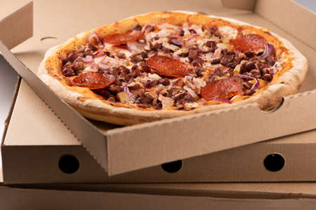 Pizza in a cardboard box close upの写真素材