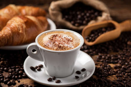 A cup of cappuccino with coffee beanの写真素材