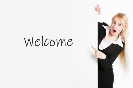 A blonde business woman with long hair holding a welcome sign boardの写真素材