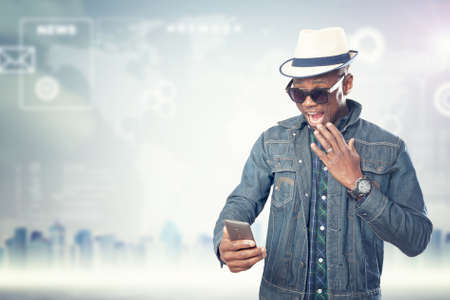 Young american african guy with cell phone. Handsome man. Device connecting people concept