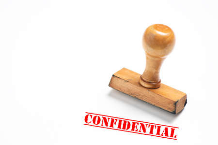 Rubber stamp with confidential sign on white background. Close upの写真素材