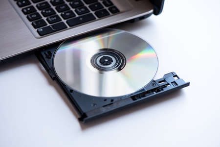 A laptop with compact disc close up shootの写真素材