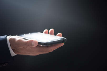Business Man using Mobile Phone. Close up
