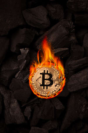 Burning golden bitcoin coin close upの写真素材