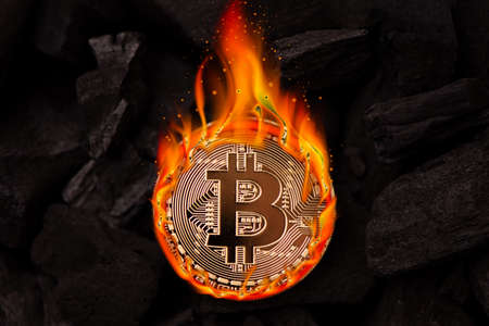 Burning golden bitcoin coin close up