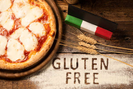 A gluten free pizza on  a rustic woodの写真素材