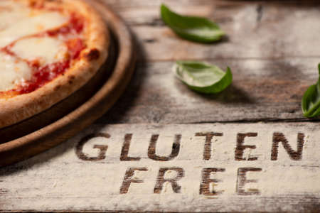 A gluten free pizza on  a rustic woodの写真素材