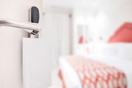 Half opened door handle closeup, entrance to a hotel room close upの写真素材