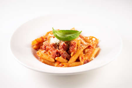 Italian Amatriciana Pasta with tomato sauce and smoked bacon served on white plateの写真素材