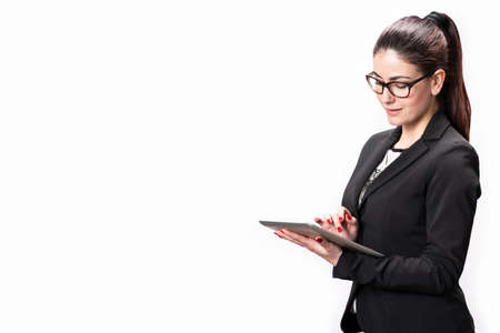 Beautiful female corporate worker with tablet on whiteの写真素材