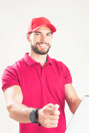 Young delivery man holding document folder ask to sign invoiceの写真素材