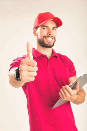 Young delivery man holding document folder ask to sign invoice