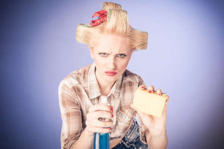 Portrat of af  a Pin up Young  Blonde girl with cleaning product isolated
