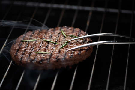 A beef burger grill cooking close up