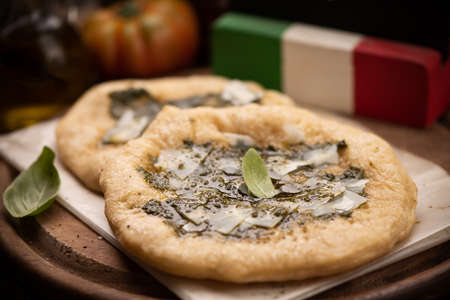 Italian stone baked  with  pesto sauce and parmesan cheese produced in Italy close up