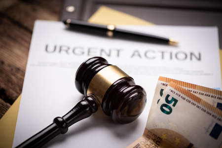Judge s hammer gavel and euro money on a desk. Close up
