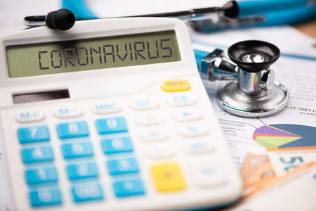 Coronavirus epidemic and its financial consequences. A calculator with the word CORONAVIRUS close upの写真素材