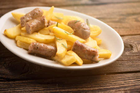 White plate of  italian sausage and potatoes close upの写真素材