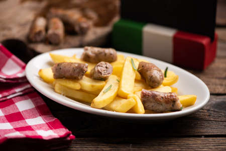 White plate of  italian sausage and potatoes close upの写真素材