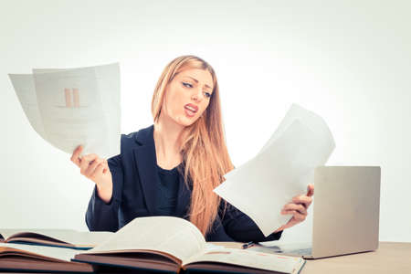 Blond woman feeling stress because of paper work at office isolated