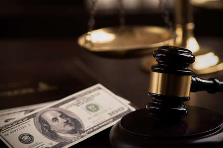 udges Hammer or Gavel With Money Heap On dark Background close upの写真素材