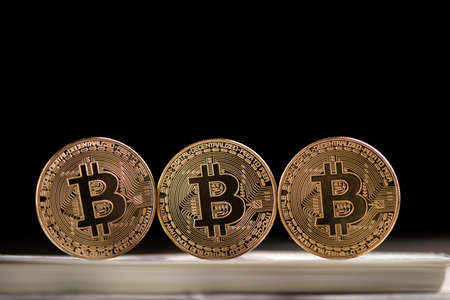 Golden Bitcoin digital currency, financial industry, Black background close upの写真素材