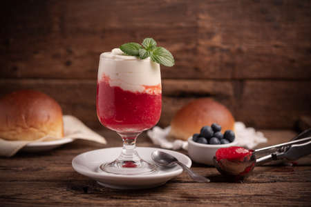 A delicious breakfast with strawberry granita and brioches, sicily, close up