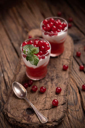 Smoothie made of red frozen berries in different small glasses close upの写真素材
