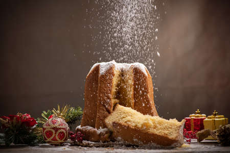 Traditional Italian Christmas cake Pandoro with christmas decoration and gifts. Close upの写真素材