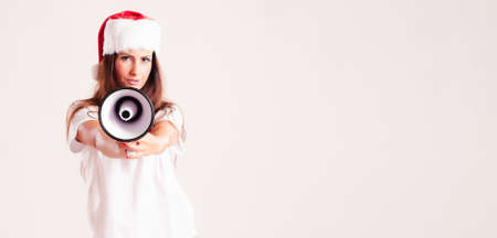 Santa woman screaming by megaphone. Isolated on whiteの写真素材
