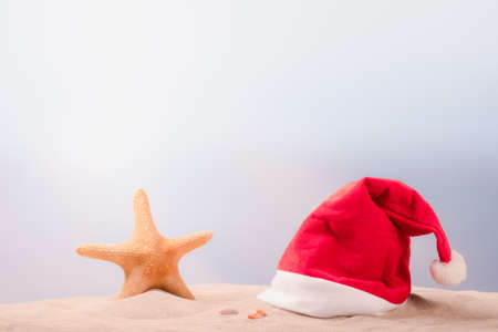 Santa claus hat on sand beach.Christmas holidays concept.の写真素材